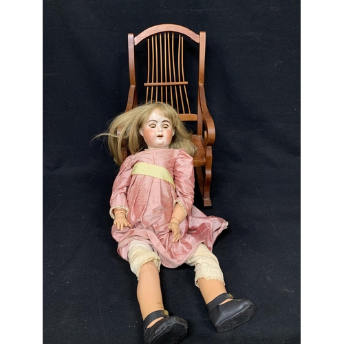 788 - German bisque Head doll and rocking chair, height 64 cms