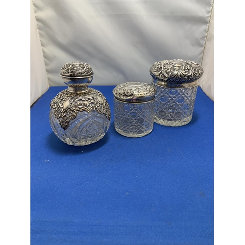 874 - Hallmarked Silver mounted scent bottle height 11 cms, (no damage) and two Silver Topped dressing tab... 