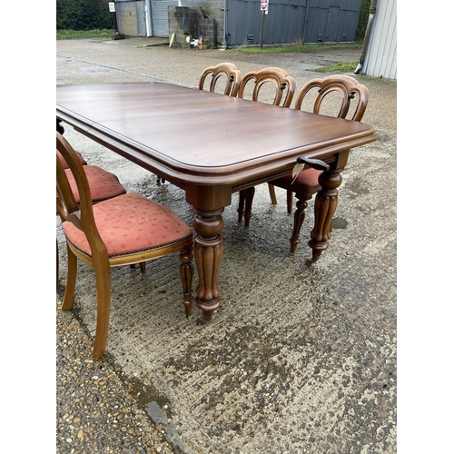 1 - A reproduction mahogany wind out dining table with one extension leaf, together with a set of six re... 