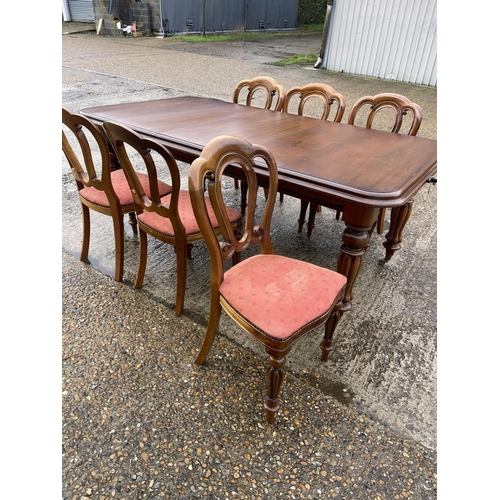 1 - A reproduction mahogany wind out dining table with one extension leaf, together with a set of six re... 