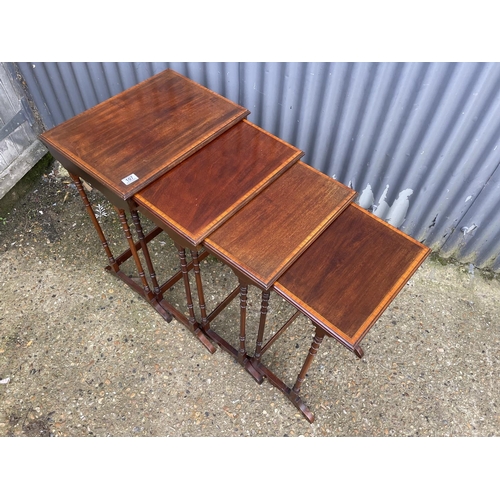 107 - An Edwardian mahogany inkaid nest of four tables