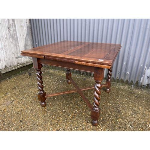 11 - An oak barley twist drawer leaf dining table