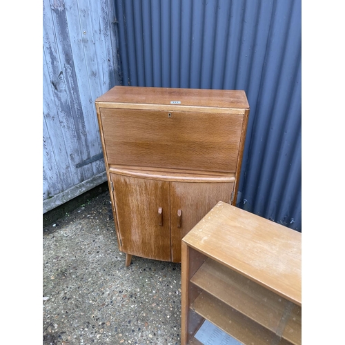 111 - A mid centuey light oak bureau together with a light oak glazed bookcase