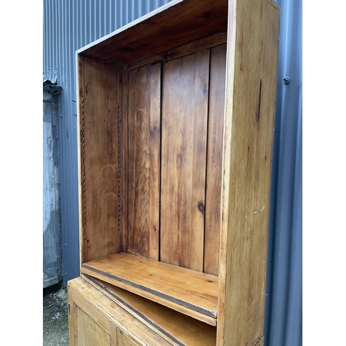 126 - A country pine bookcase cupboard with three adjusting shelves (lacking shelf pegs)