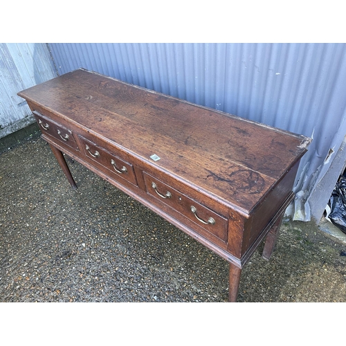 138 - An early oak three drawer dresser base