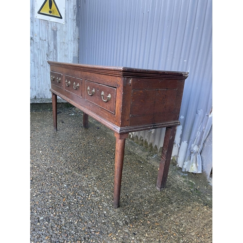 138 - An early oak three drawer dresser base