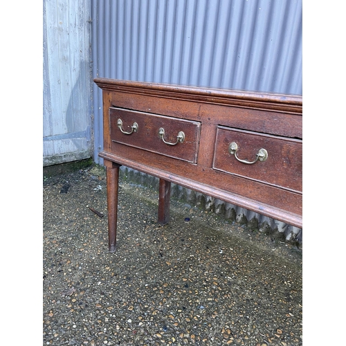 138 - An early oak three drawer dresser base