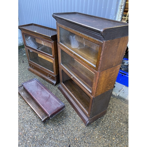 140 - Two early 20th century oak sectional bookcases by GUNN with glazed up and over doors (one glass MISS... 