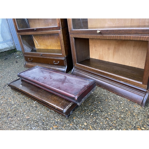 140 - Two early 20th century oak sectional bookcases by GUNN with glazed up and over doors (one glass MISS... 