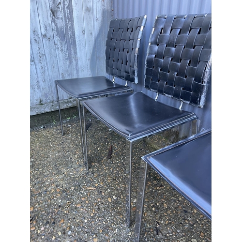 148 - A set of four modern black leather and chrome dining chairs