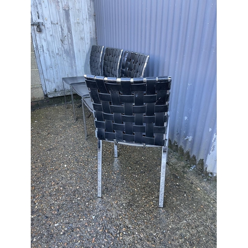 148 - A set of four modern black leather and chrome dining chairs