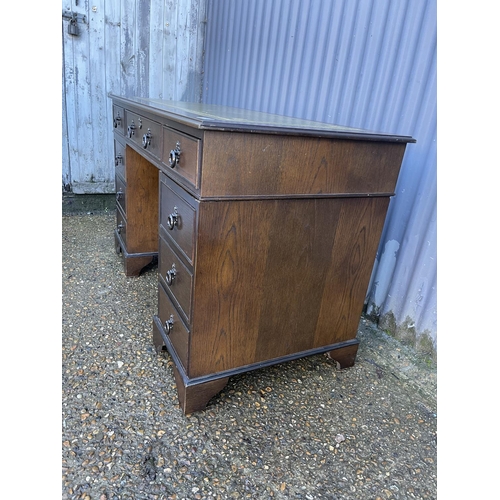 151 - An oak twin pedestal office desk with a green leather top