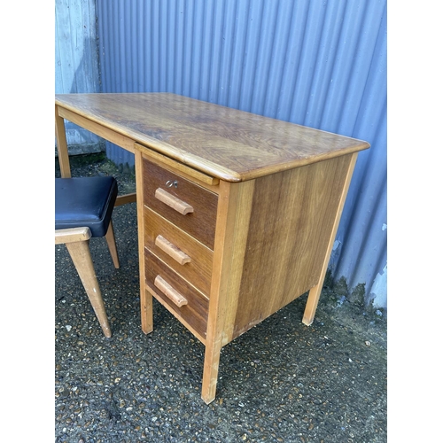 152 - A mid century oak writing desk together with a black vinyl BENCHAIR office chair