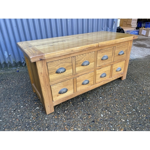 155 - A modern light oak double sided coffee table with sliding top and two drawers