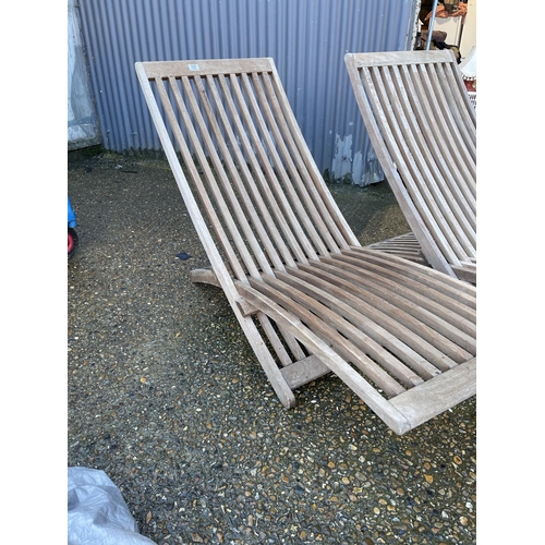 157 - A pair of folding hardwood garden sun loungers labelled LINDSEY