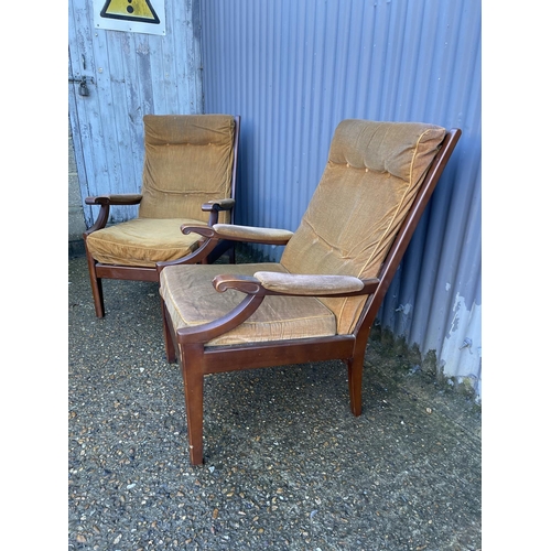 158 - A pair of mid century teak armchairs