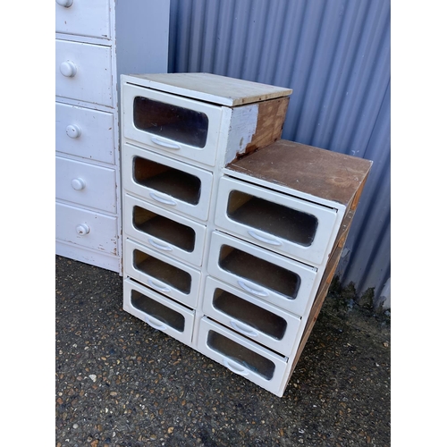 162 - A white painted bank of shop drawers together with another white painted chest