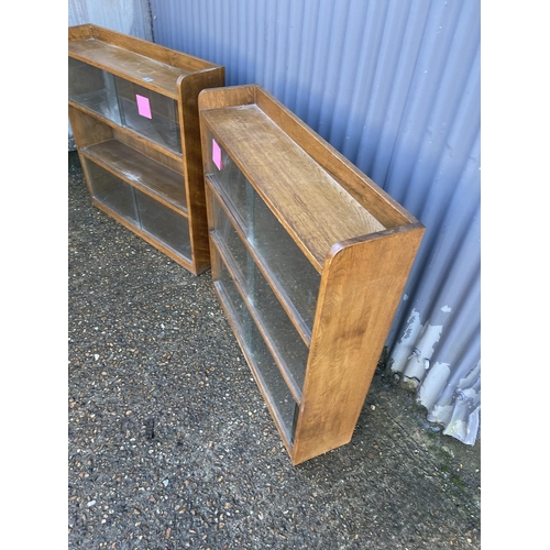 165 - A pair of mid century light oak glazed bookcases