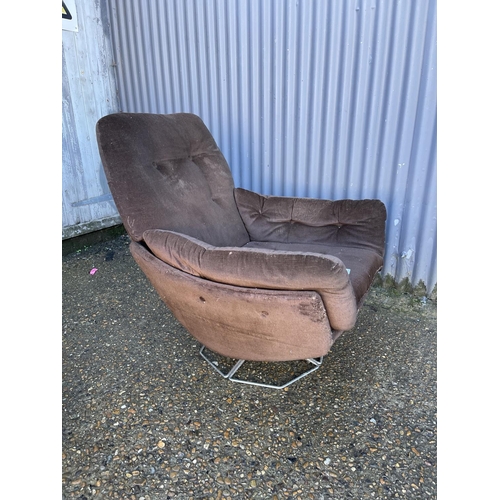 185 - A mid century brown upholstered swivel chair on chrome base