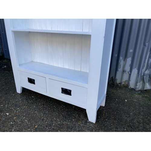 186 - A white painted open fronted bookcase with two drawers