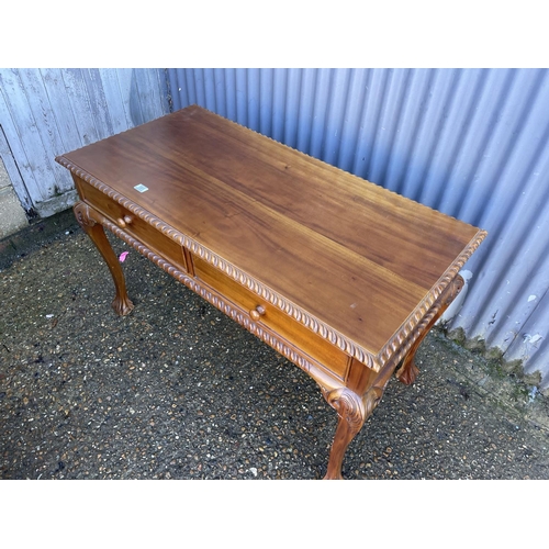 191 - A reproduction mahogany two drawer writing table