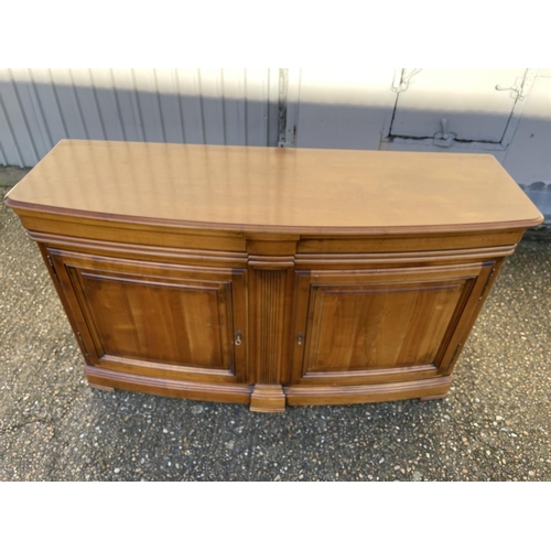 195 - A large reproduction mahogany bow front sideboard with two drawers and two cupboard doors