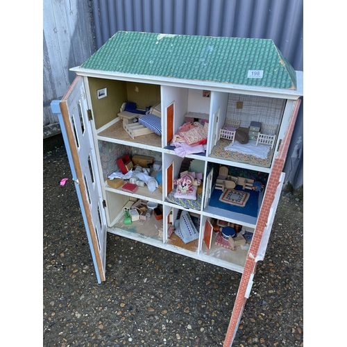 198 - A vintage dolls house with furniture