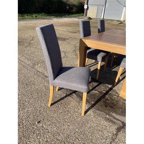 200 - A modern light oak dining table together with six modern grey upholstered high back chairs