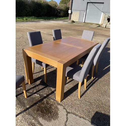 200 - A modern light oak dining table together with six modern grey upholstered high back chairs