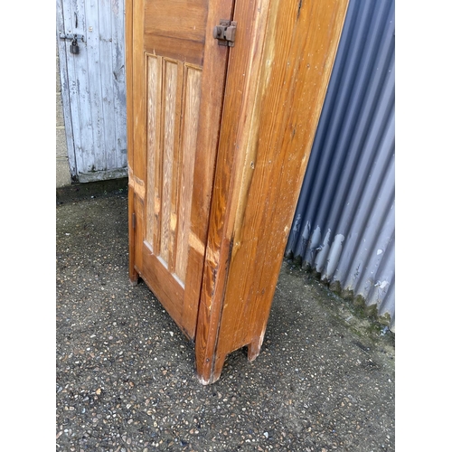 222 - A tall vintage pine larder cupboard with shelves to the interior