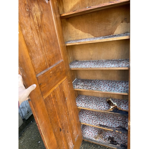 222 - A tall vintage pine larder cupboard with shelves to the interior