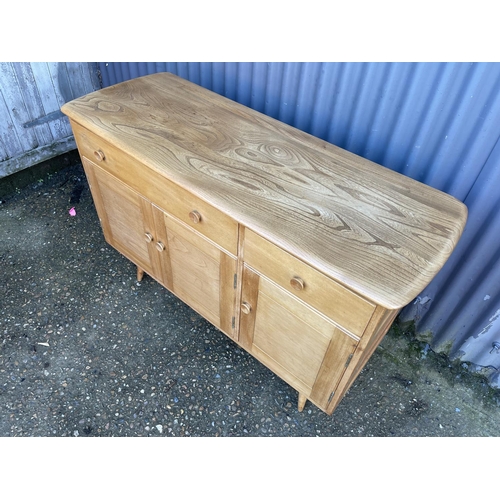 229 - A mid century light elm Ercol sideboard