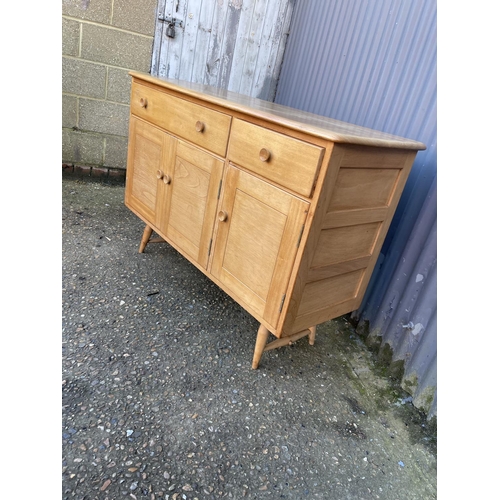 229 - A mid century light elm Ercol sideboard