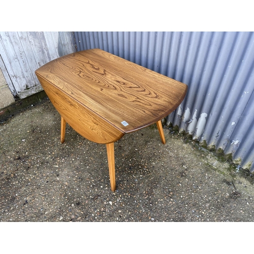 231 - An ercol elm drop leaf dining table