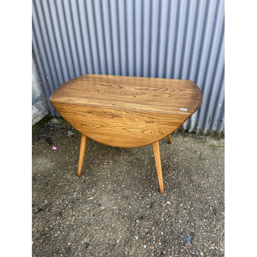 231 - An ercol elm drop leaf dining table