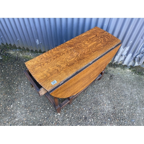 258 - An oak gate leg table with drawer