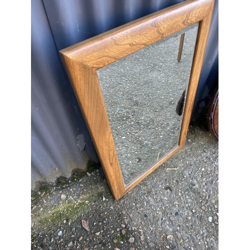 264 - An ercol square mirror together with a oval mirror