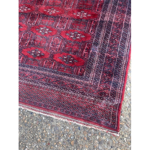 270 - A red oriental pattern rug