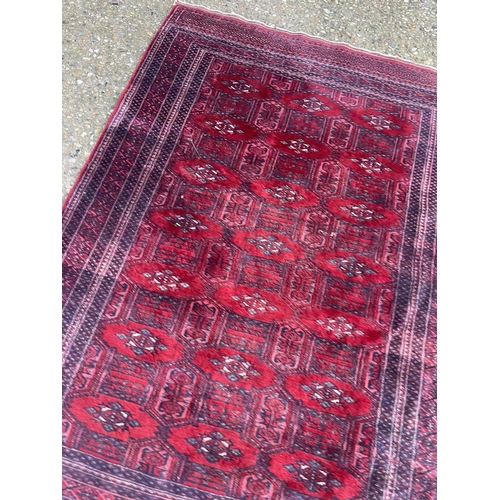 270 - A red oriental pattern rug