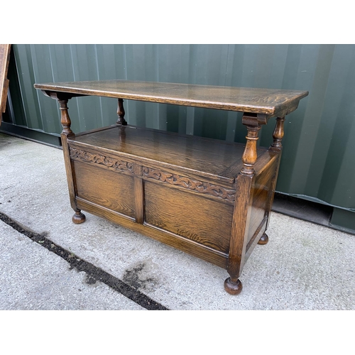 273 - A large early 20th century oak monks bench carved to the front