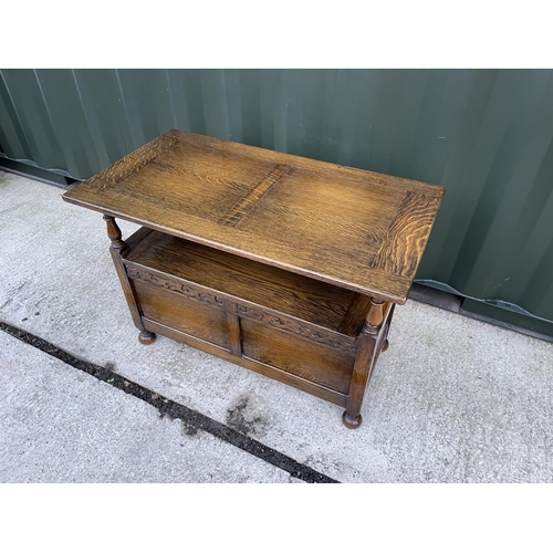 273 - A large early 20th century oak monks bench carved to the front