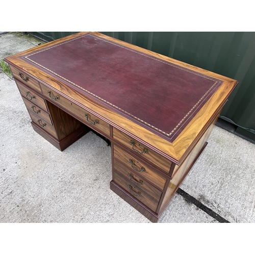 275 - A large reproduction mahogany twin pedestal desk with red leather top 5ft. X3ft