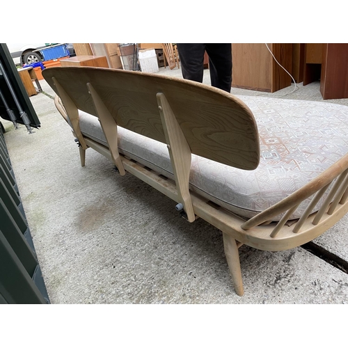 281 - An original ercol light elm day bed with web seat, removable plank back board and original cushion s... 