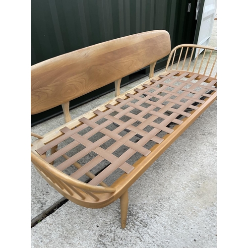 281 - An original ercol light elm day bed with web seat, removable plank back board and original cushion s... 