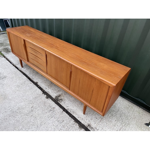 282 - A mid century danish teak sideboard with three sliding doors and three drawers marked MOBLER - MASE ... 