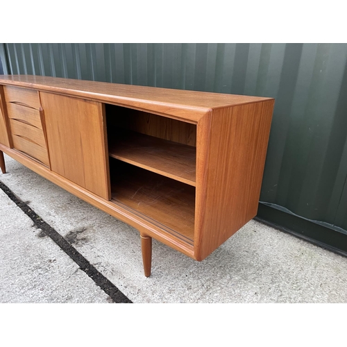 282 - A mid century danish teak sideboard with three sliding doors and three drawers marked MOBLER - MASE ... 