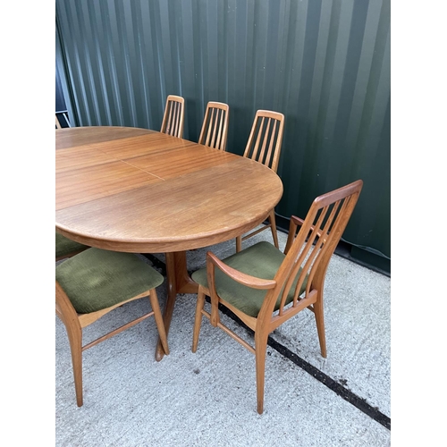 283 - An extending teak dining table with two extension leaves together with a set of 8 Danish teak dining... 