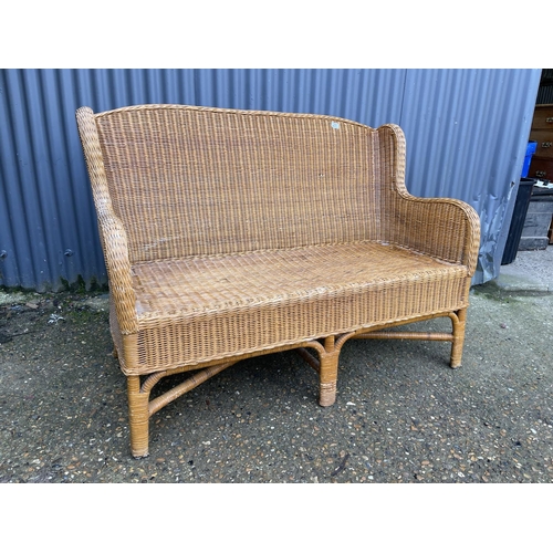 29 - A wicker two seater sofa