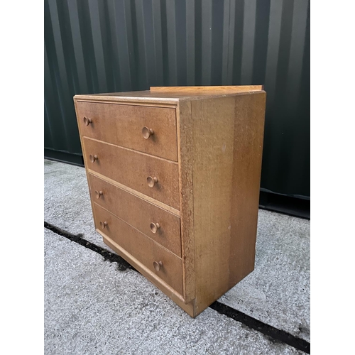 295 - A mid century light oak chest of four drawers