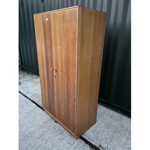 296 - A light oak double wardrobe